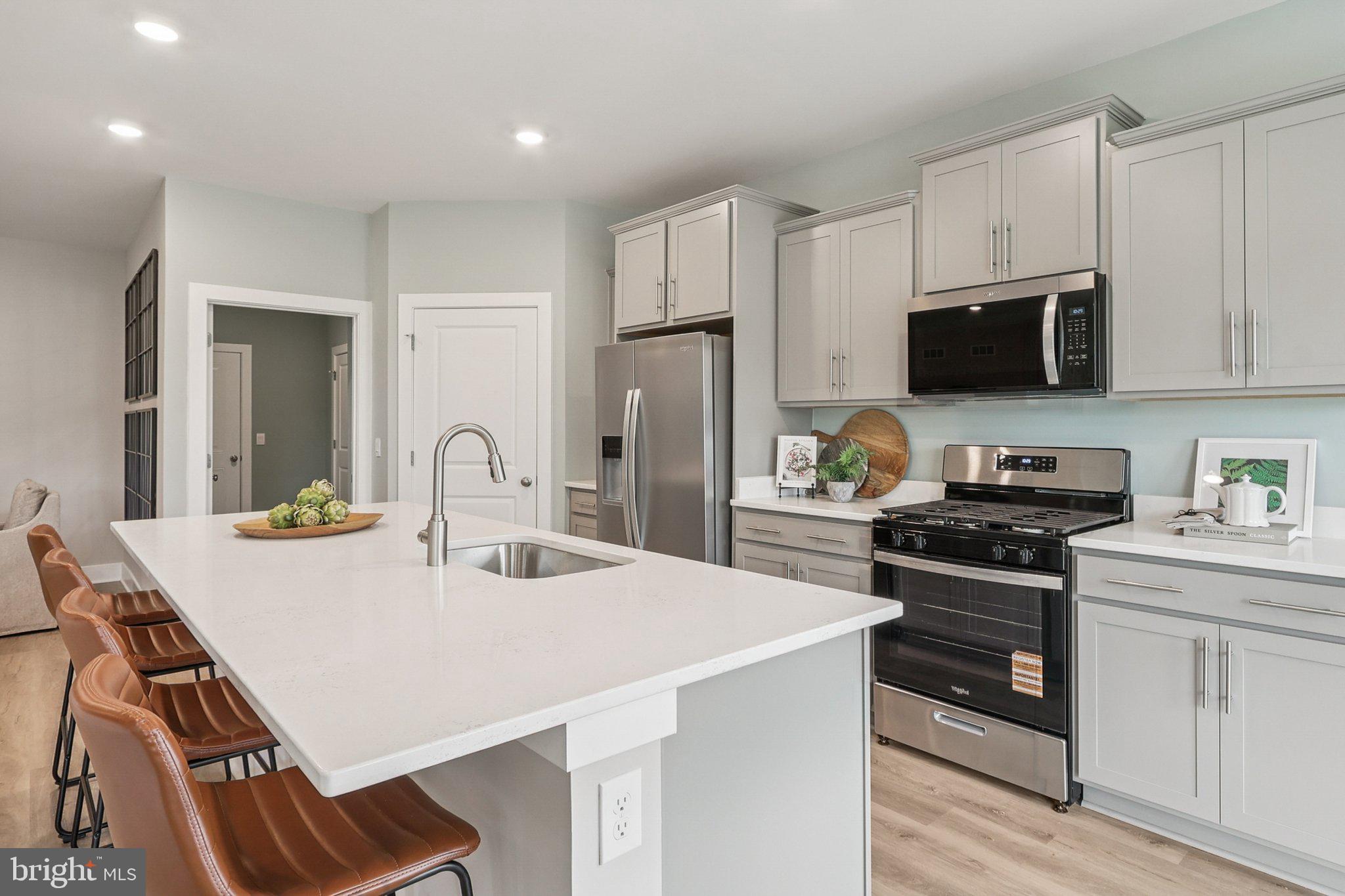 121 Hydrangea Way Winchester, VA 22602 - Photo 24 of 83 a kitchen with stainless steel appliances a stove sink microwave and cabinets