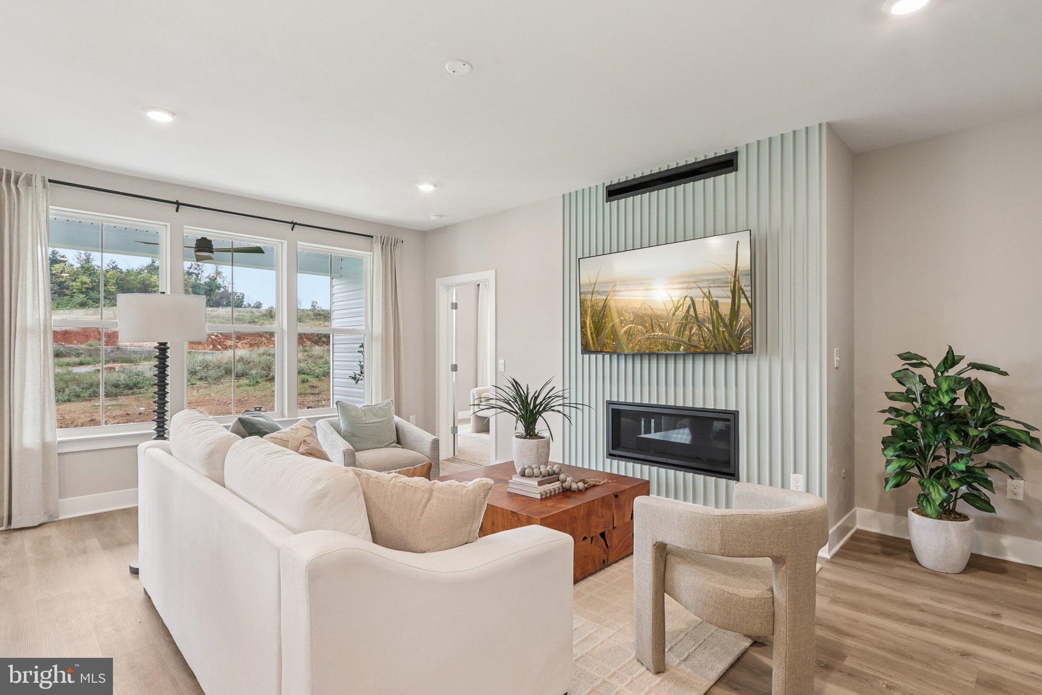 121 Hydrangea Way Winchester, VA 22602 - Photo 7 of 83 a living room with furniture fireplace and a flat screen tv