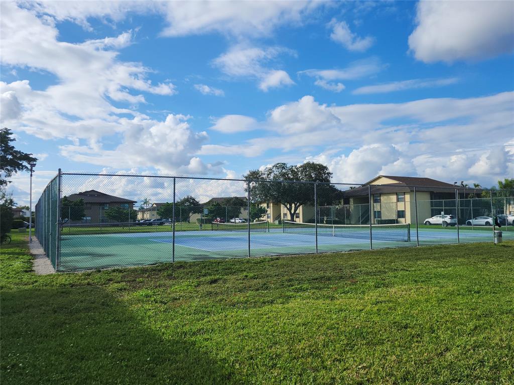 10004 Winding Lake Road, Unit 101 Sunrise, FL 33351 - Photo 17 of 17 a view of a big yard with a house in the background