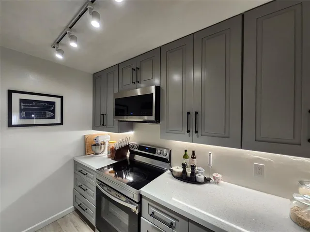 a kitchen with a stove and a microwave