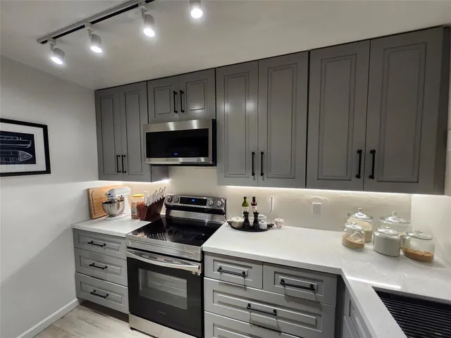 a kitchen with granite countertop a stove and a sink