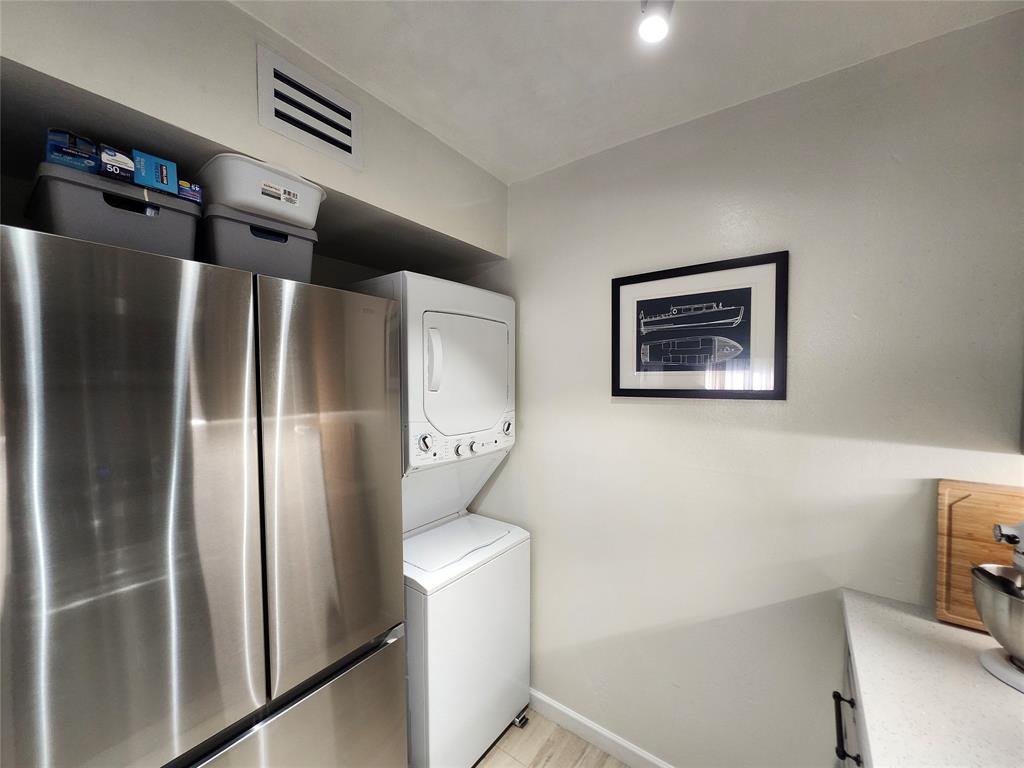 10004 Winding Lake Road, Unit 101 Sunrise, FL 33351 - Photo 6 of 17 a metallic refrigerator freezer sitting in a kitchen