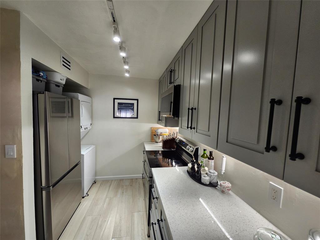 10004 Winding Lake Road, Unit 101 Sunrise, FL 33351 - Photo 8 of 17 a very nice looking room with wooden floor