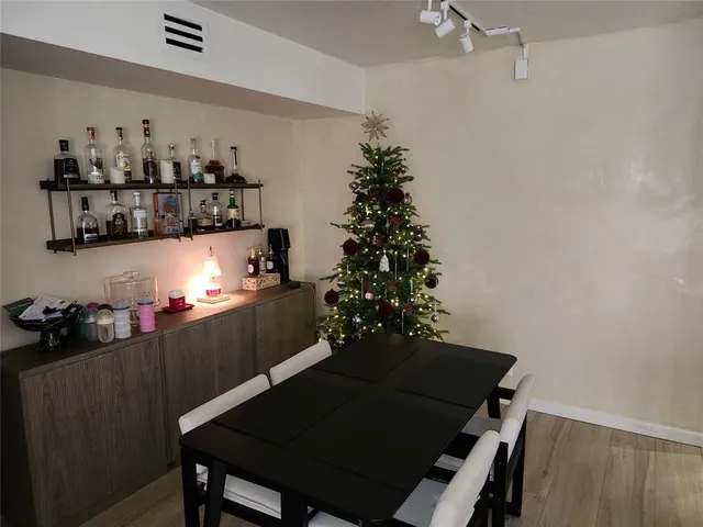 a view of a dining room with furniture and chandelier