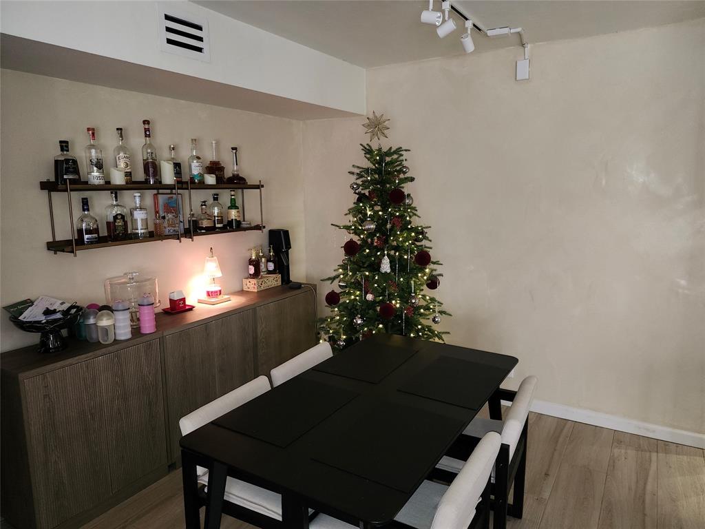 10004 Winding Lake Road, Unit 101 Sunrise, FL 33351 - Photo 9 of 17 a view of a dining room with furniture and chandelier