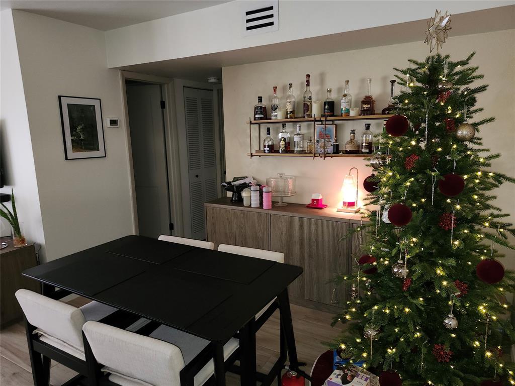 10004 Winding Lake Road, Unit 101 Sunrise, FL 33351 - Photo 10 of 17 a living room with a table chair and a potted plant