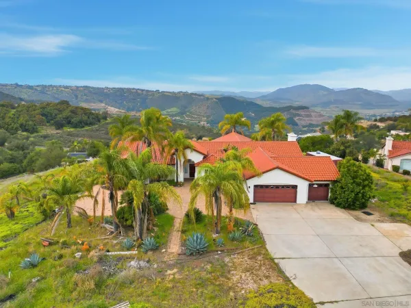 a view of multiple houses with a yard and mountain view
