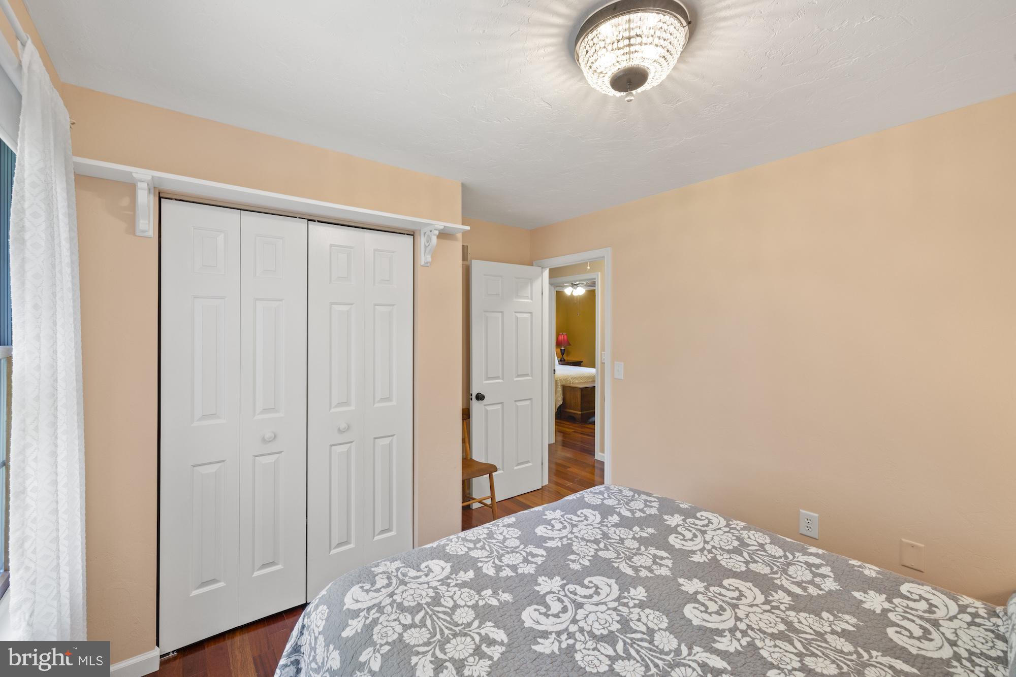 95 White Church Road Gettysburg, PA 17325 - Photo 44 of 59 a bedroom with a bed and a chandelier