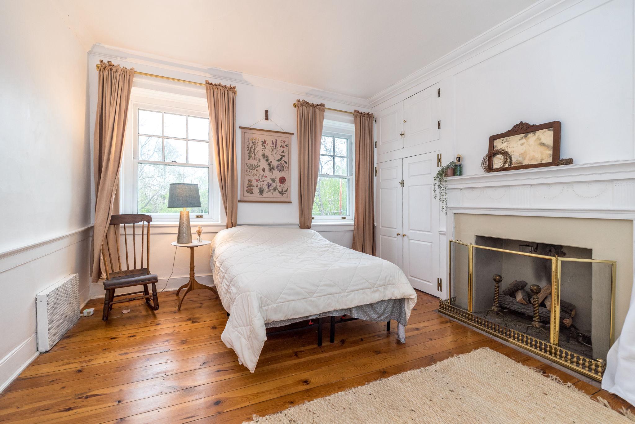 866 Schuylkill Road Birdsboro, PA 19508 - Photo 35 of 73 a spacious bedroom with a bed and a fireplace