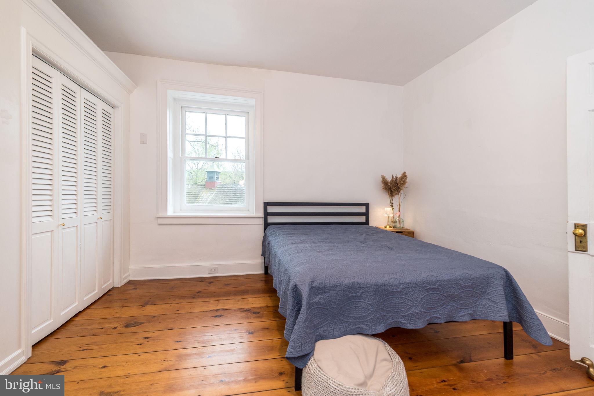 866 Schuylkill Road Birdsboro, PA 19508 - Photo 46 of 73 a bedroom with a bed and wooden floor