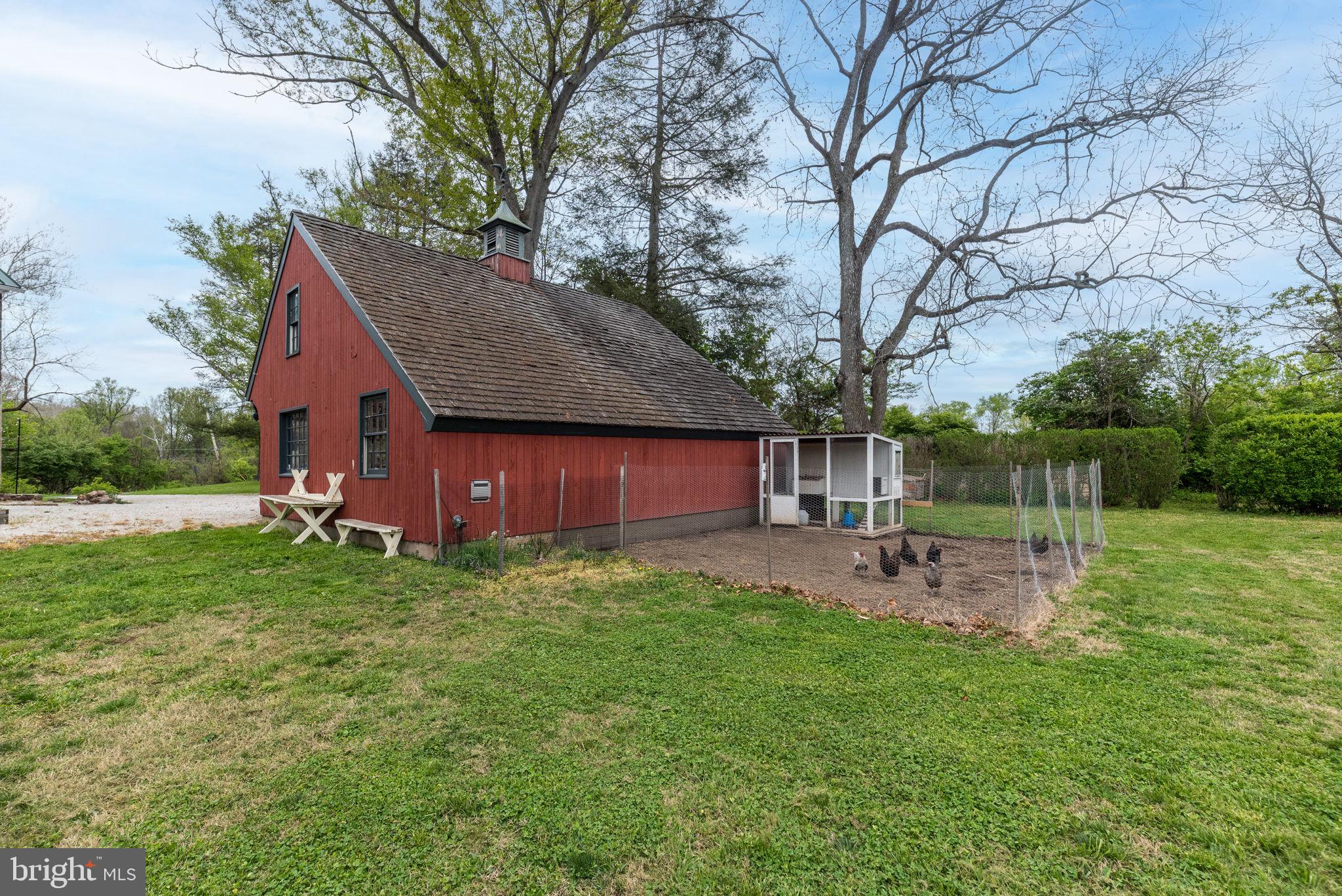 866 Schuylkill Road Birdsboro, PA 19508 - Photo 66 of 73 a view of a backyard with table and chairs with a fire pit and a large tree