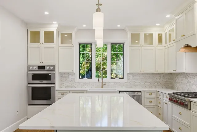 a kitchen with a stove a sink and a refrigerator