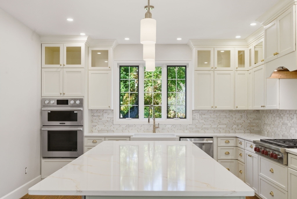 a kitchen with a stove a sink and a refrigerator