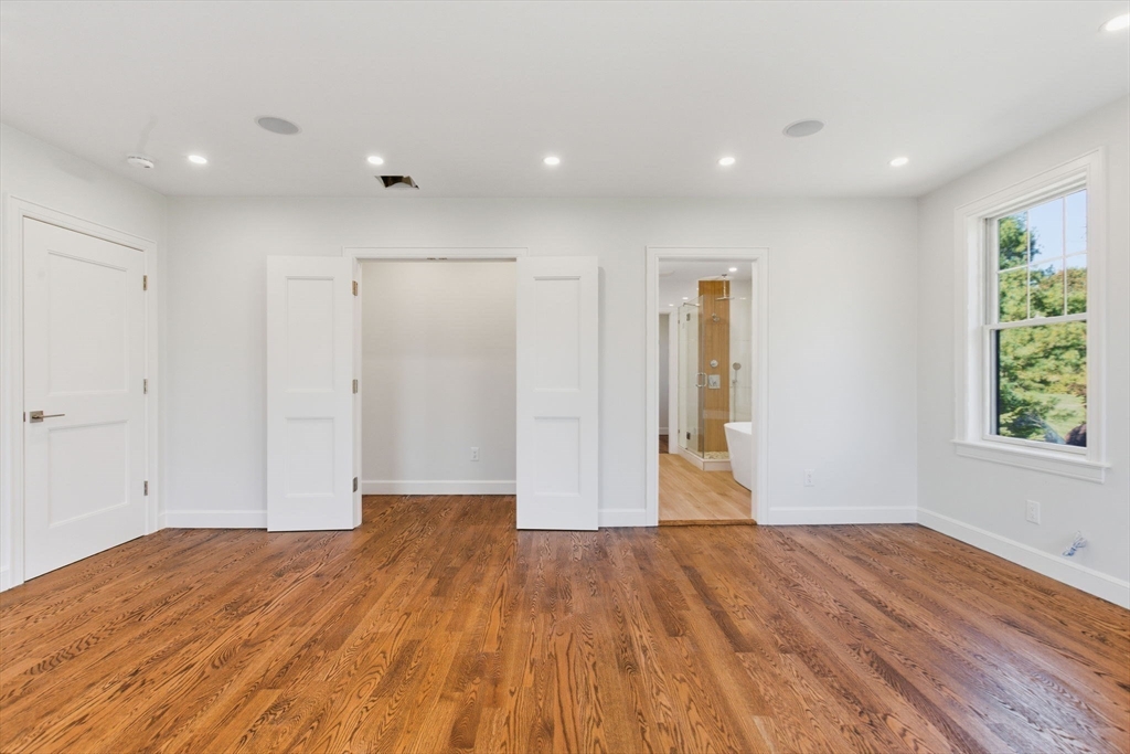 131 Maple Street Scituate, MA 02066 - Photo 13 of 38 a view of empty room with wooden floor and window