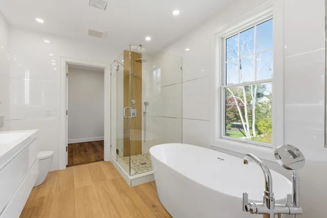 a bathroom with a tub a sink and a shower