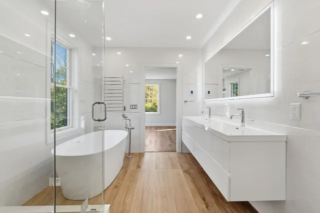 a large bathroom with a double vanity sink and a bathtub
