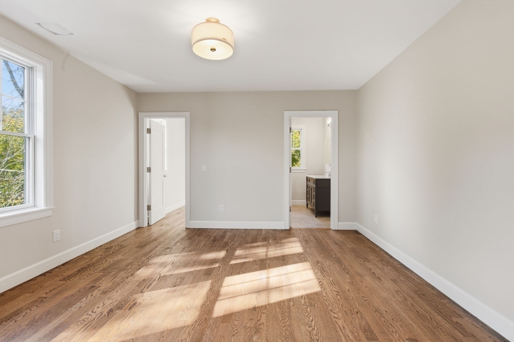 131 Maple Street Scituate, MA 02066 - Photo 26 of 38 a view of an empty room with wooden floor and a window