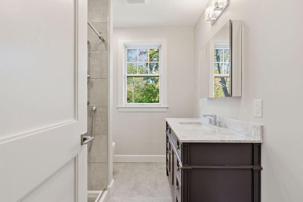 131 Maple Street Scituate, MA 02066 - Photo 27 of 38 a bathroom with a sink and a mirror