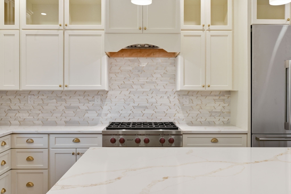 131 Maple Street Scituate, MA 02066 - Photo 3 of 38 a kitchen with granite countertop white cabinets and white appliances