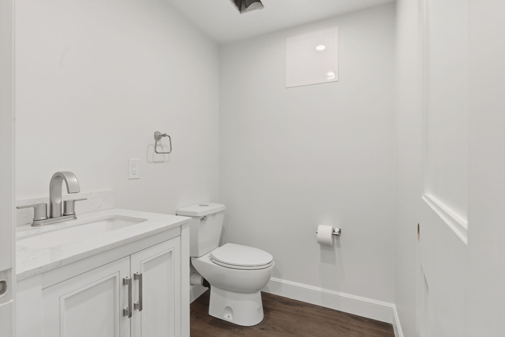 131 Maple Street Scituate, MA 02066 - Photo 36 of 38 a bathroom with a toilet a sink and mirror