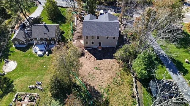 an aerial view of house with yard and seating area