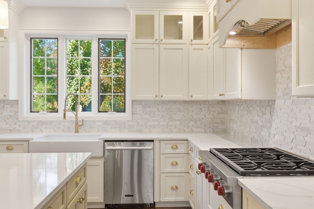 131 Maple Street Scituate, MA 02066 - Photo 4 of 38 a kitchen with granite countertop a sink a stove and cabinets