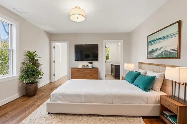 a bedroom with a bed and a flat screen television