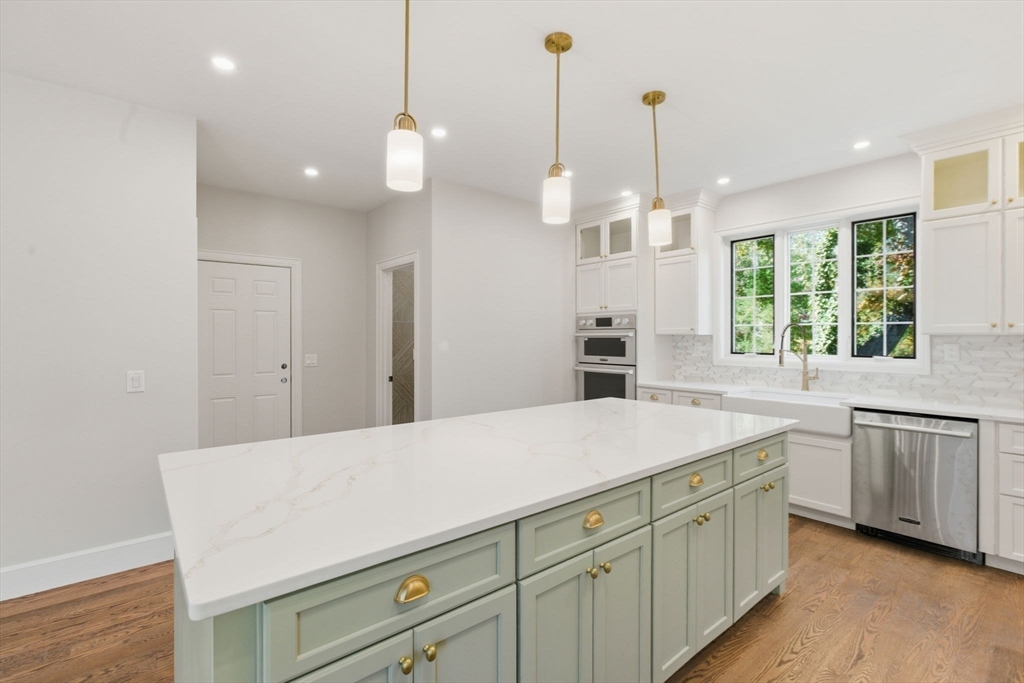 131 Maple Street Scituate, MA 02066 - Photo 5 of 38 a kitchen with a sink and dishwasher with wooden floor