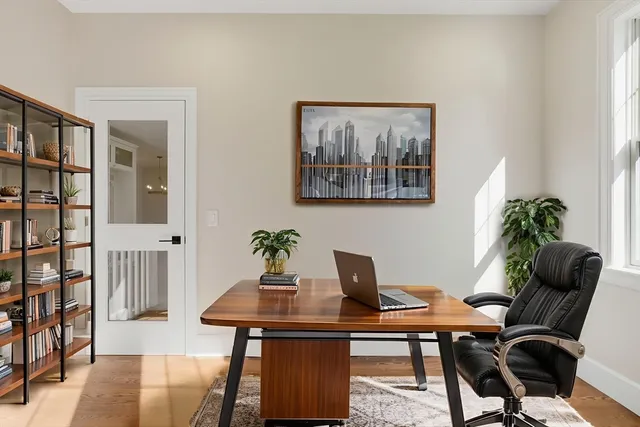 a view of a workspace with furniture and wooden floor