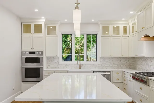 a kitchen with a stove a sink and a refrigerator