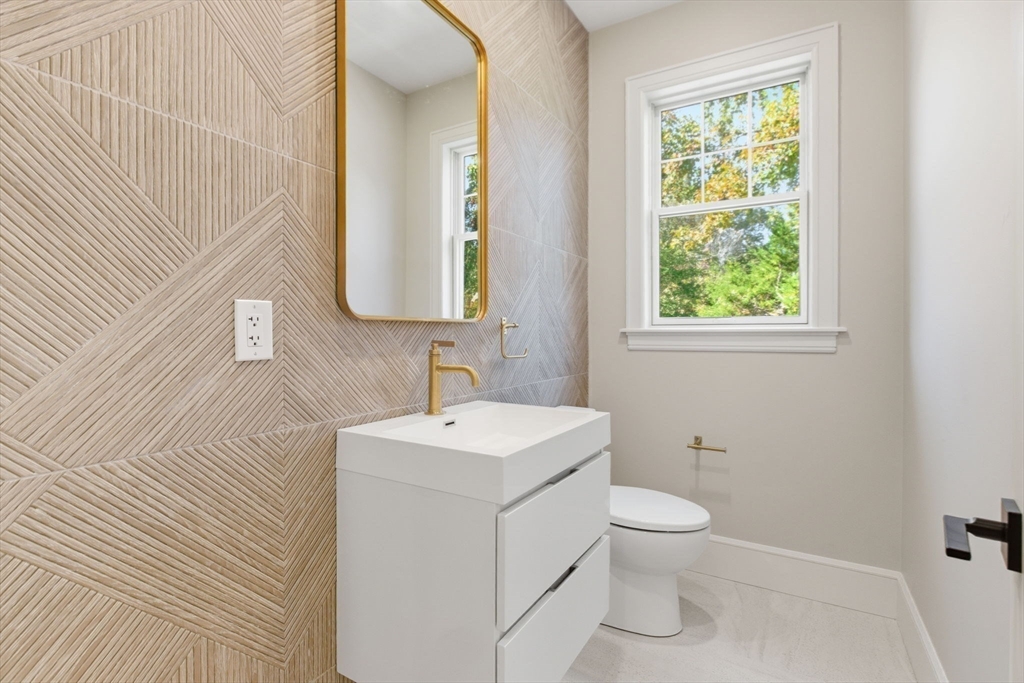 131 Maple Street Scituate, MA 02066 - Photo 9 of 38 a bathroom with a toilet sink and mirror