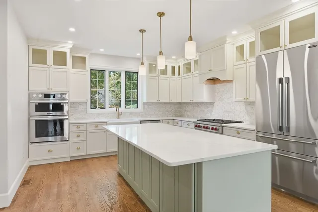 a kitchen with a stove a sink and a refrigerator