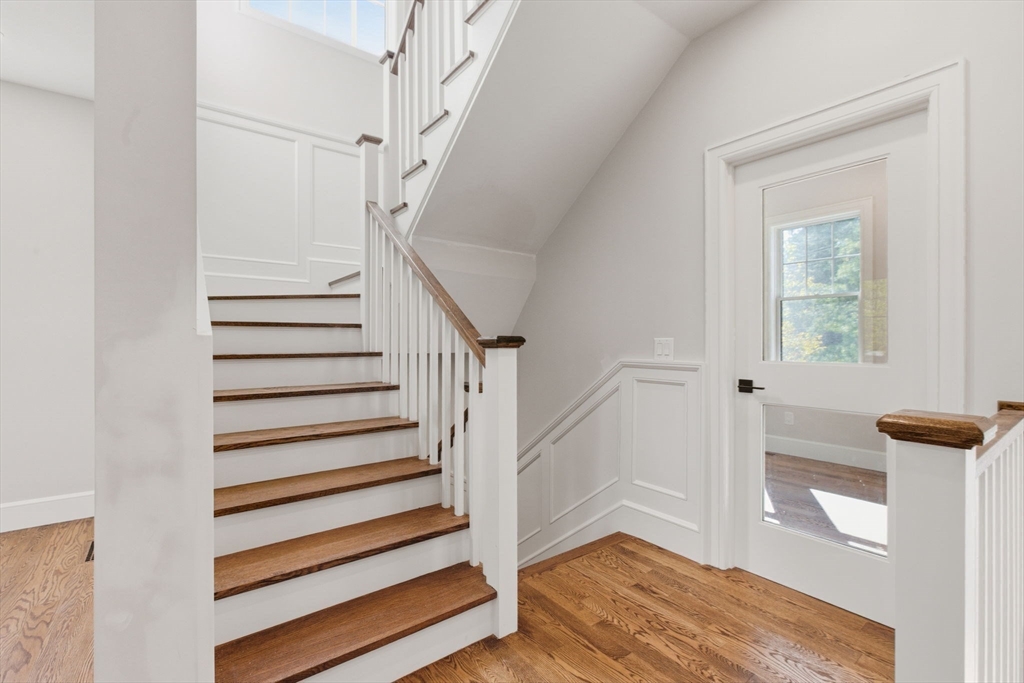 131 Maple Street Scituate, MA 02066 - Photo 10 of 38 a view of entryway with wooden floor and stairs