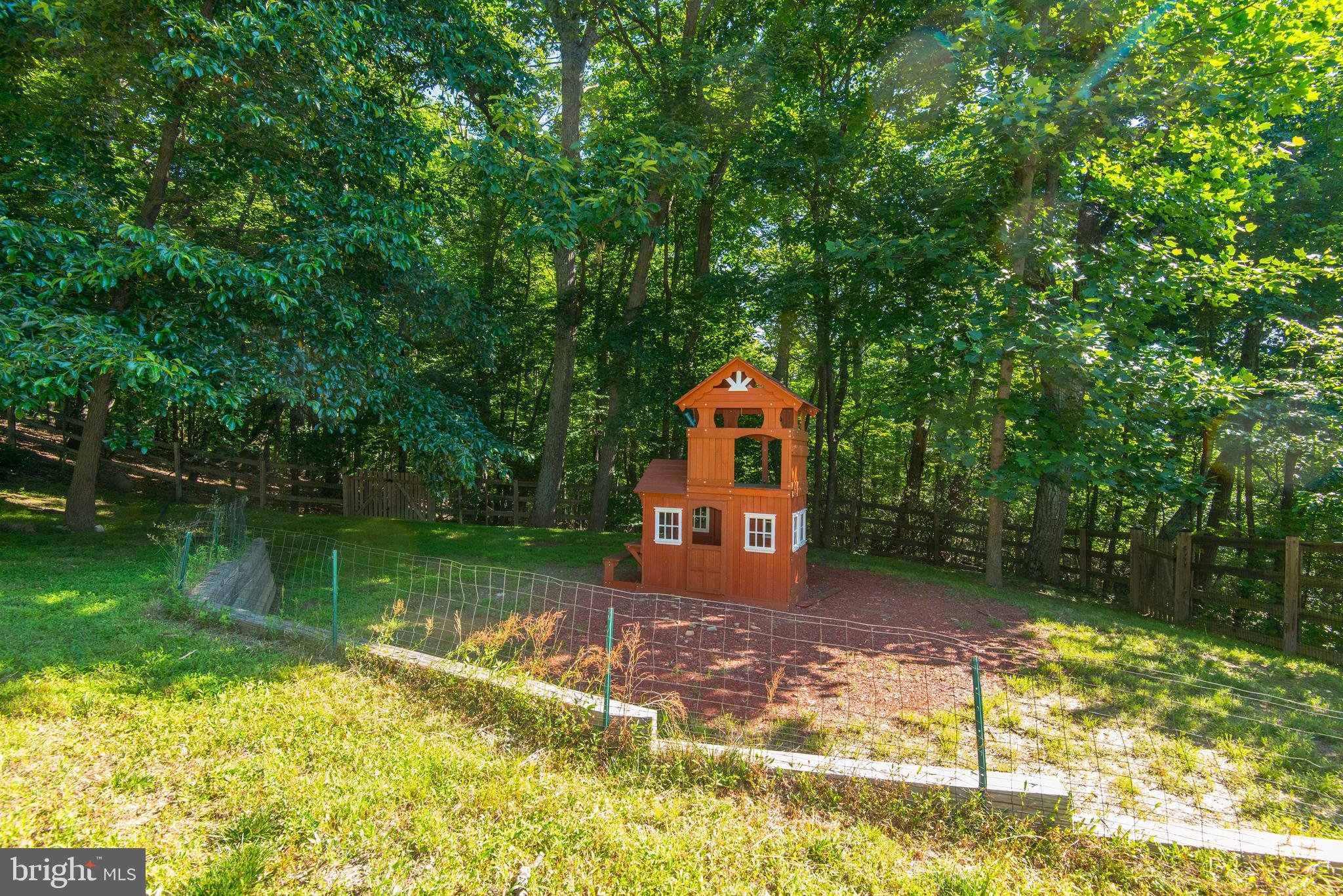 1619 Summit Drive Haymarket, VA 20169 - Photo 33 of 62 a wooden bench sitting in a lake next to a yard