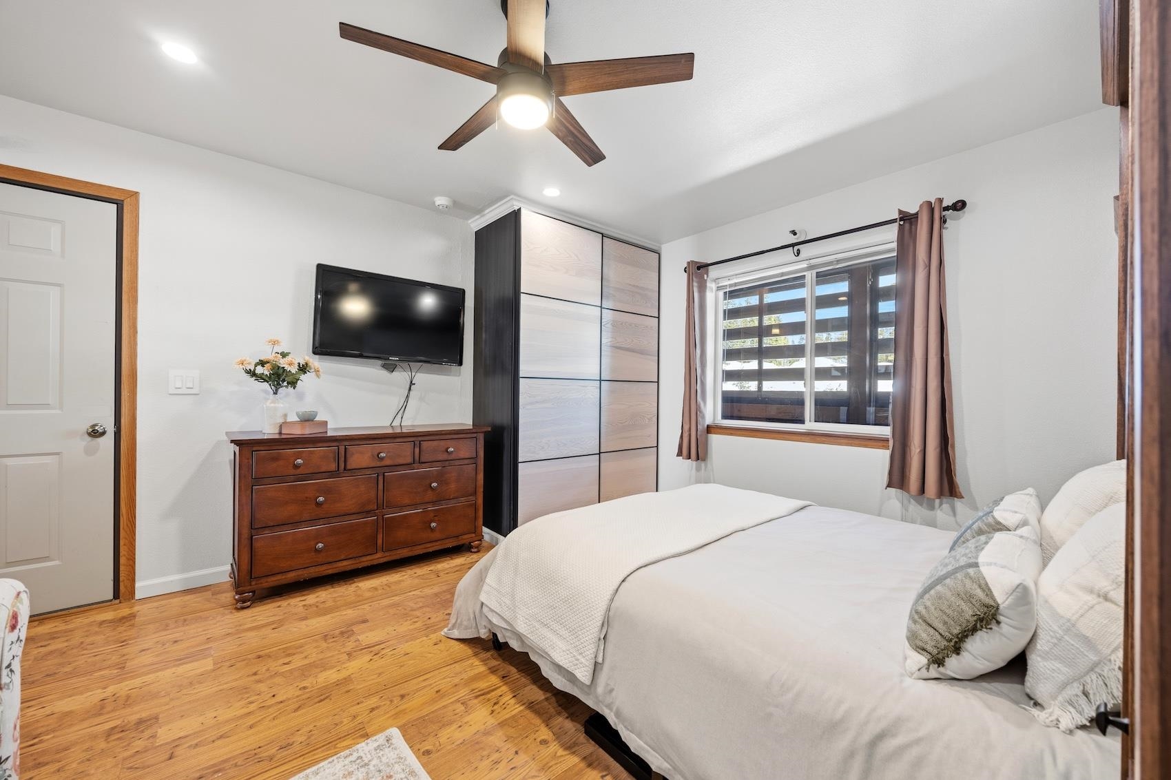 10150 Ski Ranch Lane, Unit 309 Soda Springs, CA 95728 - Photo 12 of 19 a bedroom with a bed flat screen tv and a window