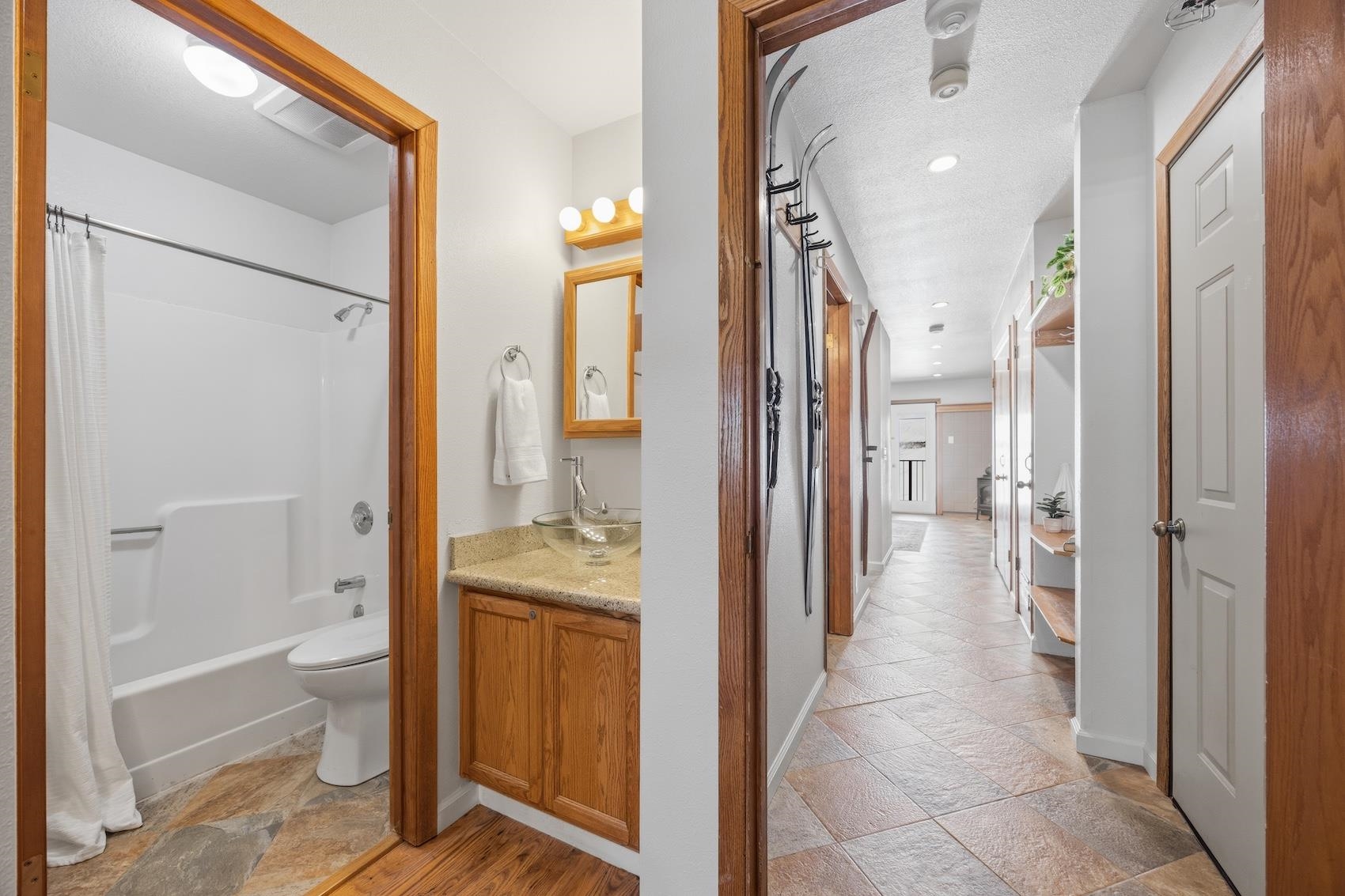 10150 Ski Ranch Lane, Unit 309 Soda Springs, CA 95728 - Photo 13 of 19 a bathroom with a granite countertop sink mirror and a bathtub