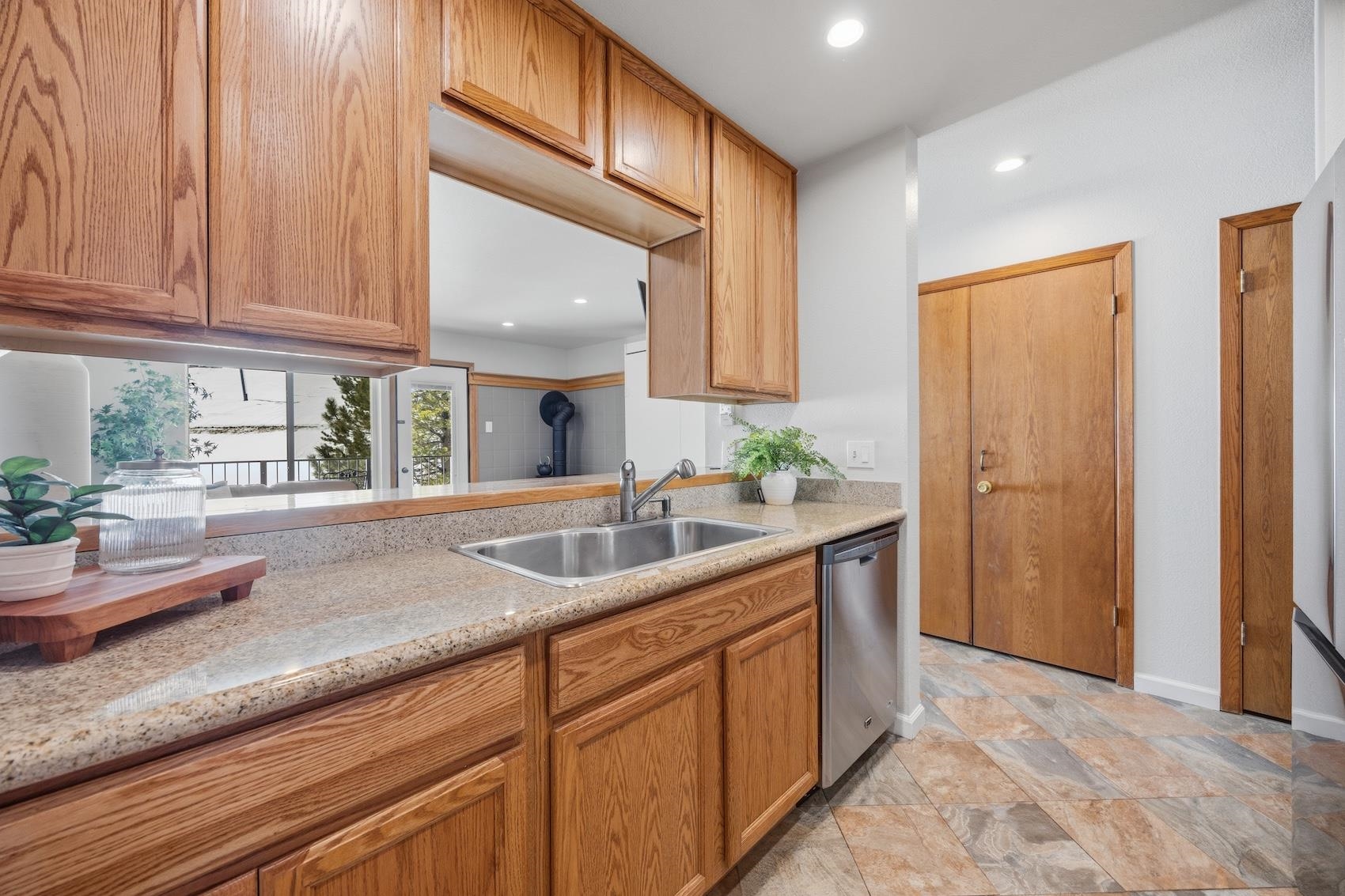 10150 Ski Ranch Lane, Unit 309 Soda Springs, CA 95728 - Photo 6 of 19 a kitchen with granite countertop a sink and white cabinets