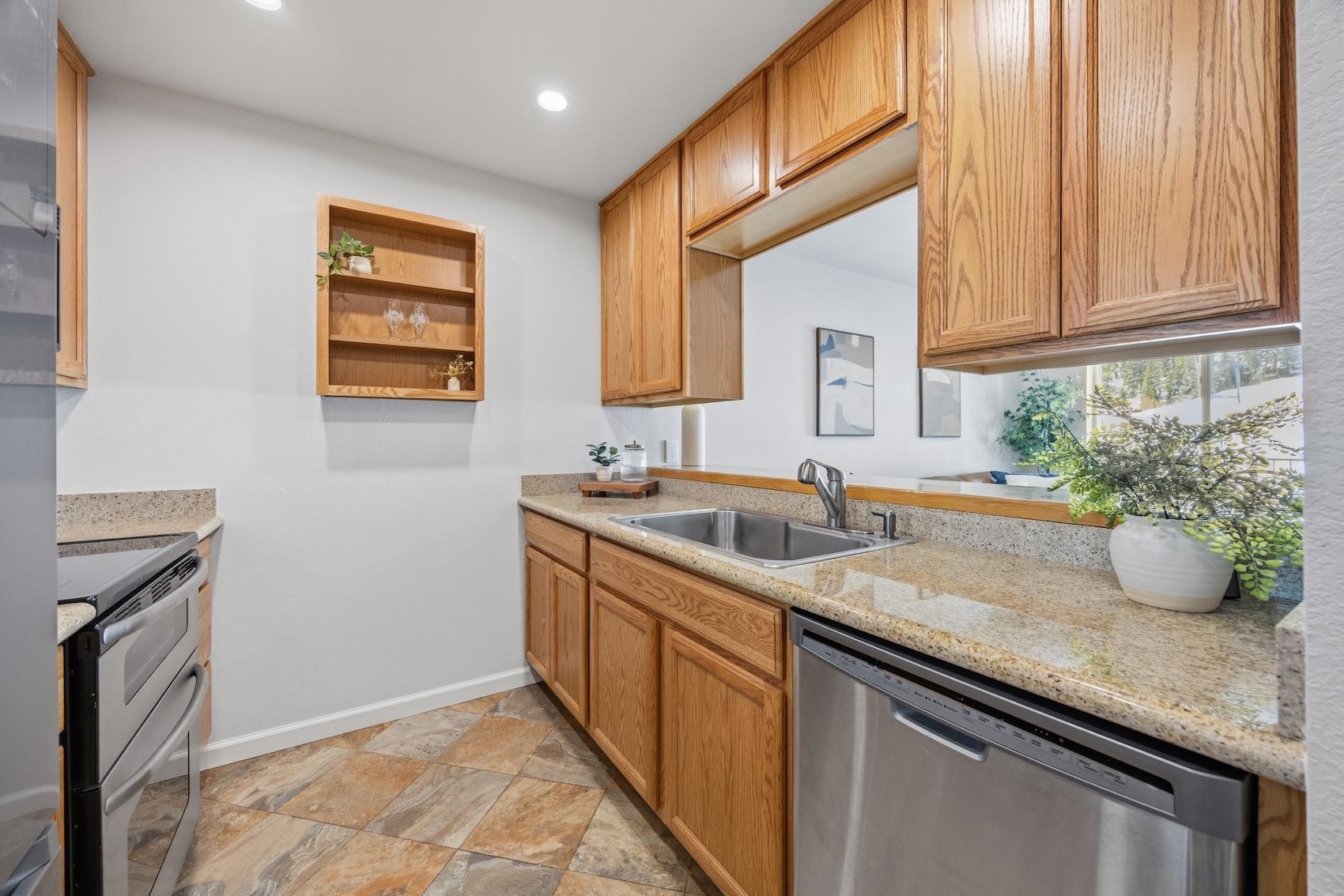 10150 Ski Ranch Lane, Unit 309 Soda Springs, CA 95728 - Photo 8 of 19 a kitchen with granite countertop a sink a stove and cabinets