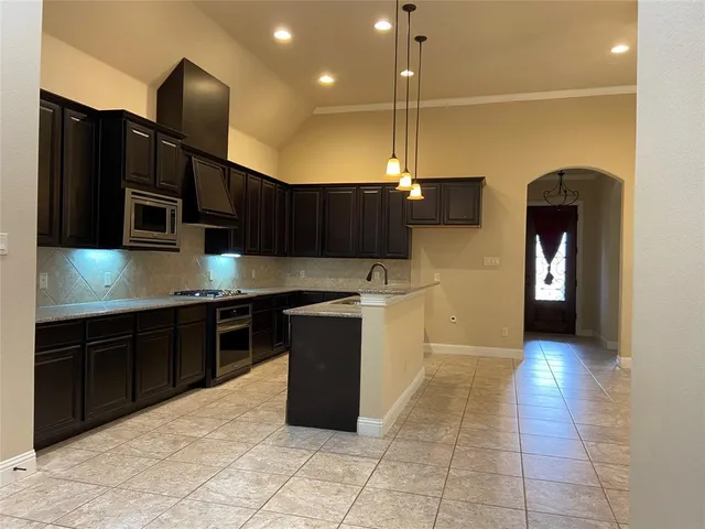 a kitchen with stainless steel appliances granite countertop a sink and cabinets