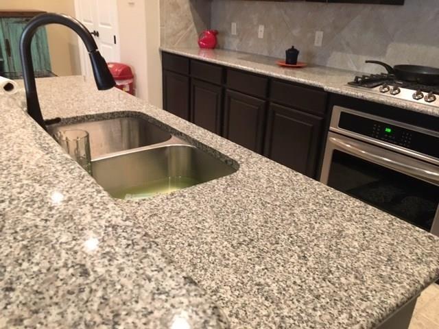 686 Pendle Forest Drive Frisco, TX 75036 - Photo 4 of 22 a kitchen with a sink and cabinets