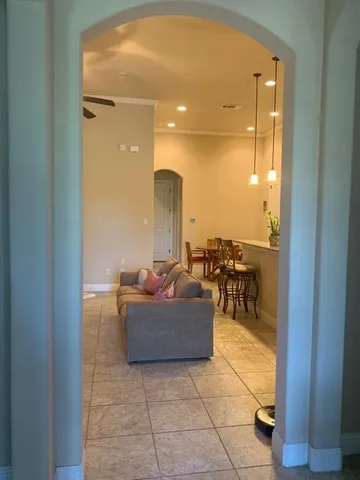 a living room with couches and kitchen view