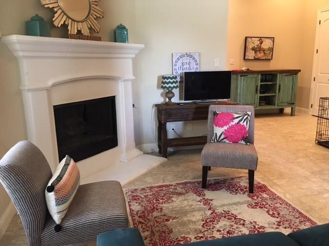 686 Pendle Forest Drive Frisco, TX 75036 - Photo 7 of 22 a living room with furniture a flat screen tv and a fireplace