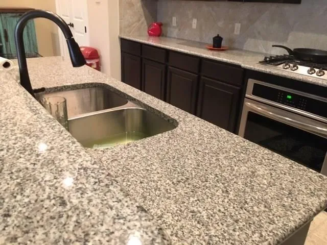 a kitchen with a sink and cabinets