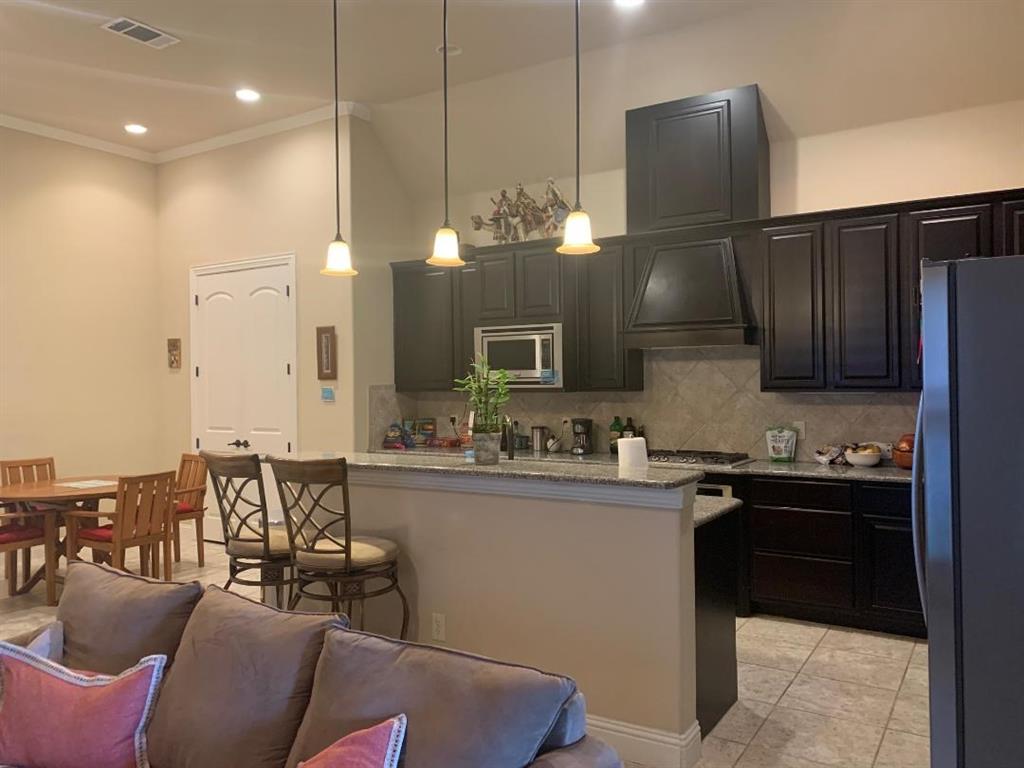 686 Pendle Forest Drive Frisco, TX 75036 - Photo 10 of 22 a kitchen with granite countertop a sink cabinets and stainless steel appliances