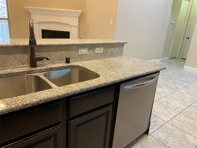 a kitchen with a sink and a refrigerator