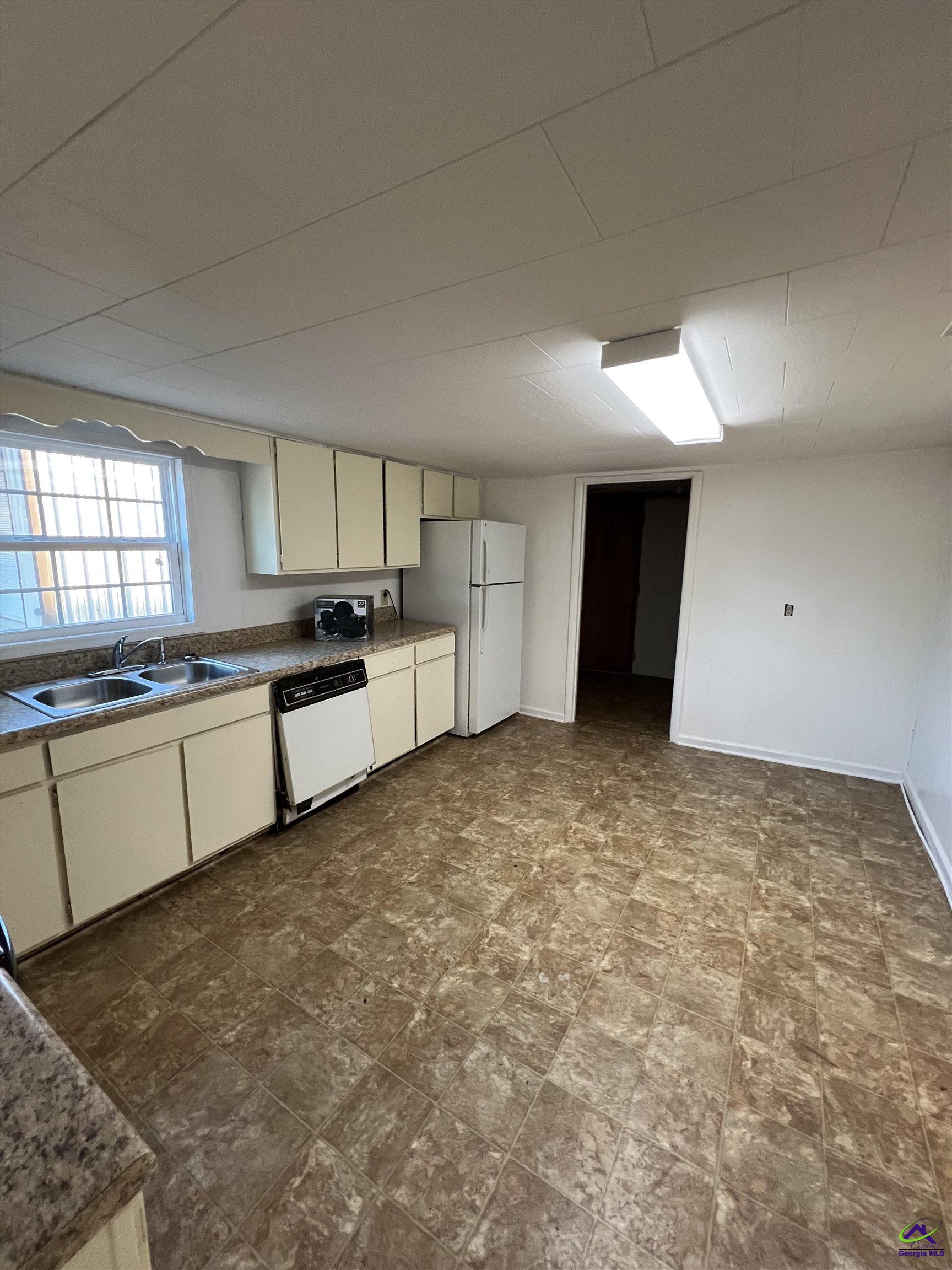 3281 State Rte 126 Dublin, GA 31021 - Photo 19 of 22 a large kitchen with a stove refrigerator sink and cabinets