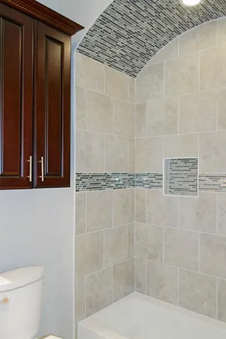 a bathroom with a shower and a toilet