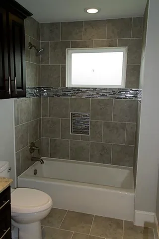a bathroom with a bathtub and a toilet