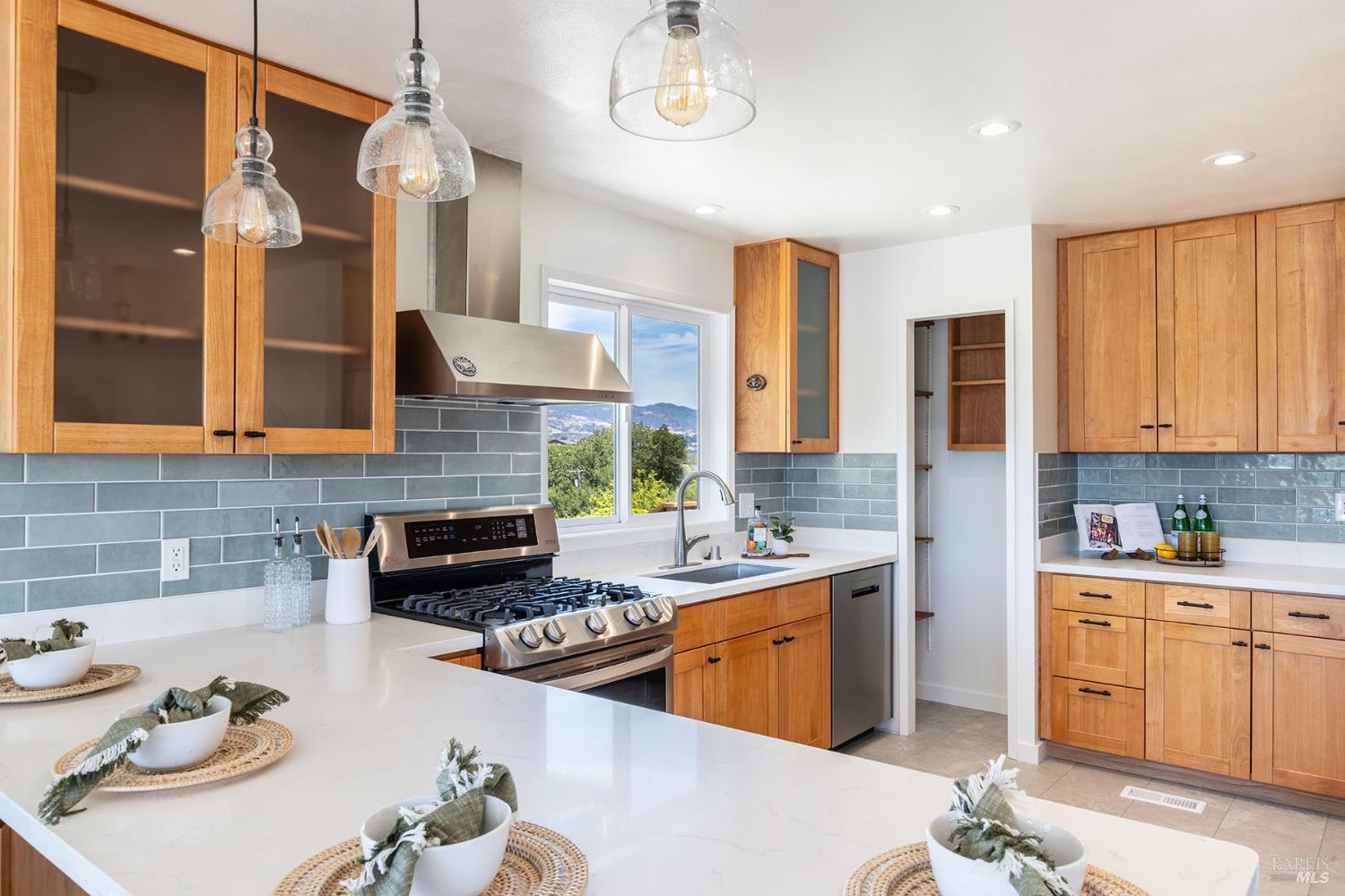 1676 Chiquita Road Healdsburg, CA 95448 - Photo 19 of 45 a kitchen with stainless steel appliances kitchen island granite countertop a sink and cabinets
