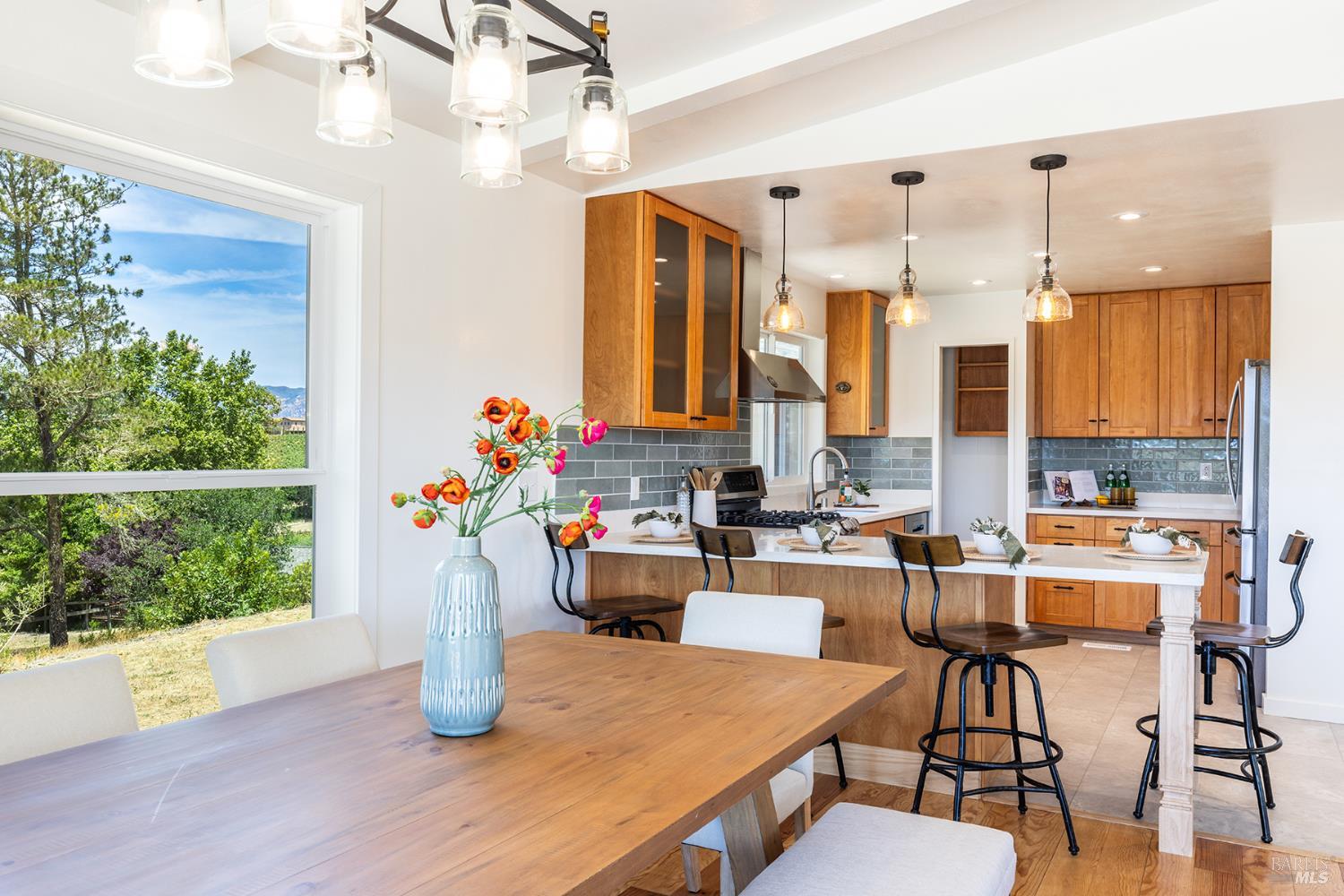1676 Chiquita Road Healdsburg, CA 95448 - Photo 20 of 45 a kitchen with a table chairs stove and wooden floor